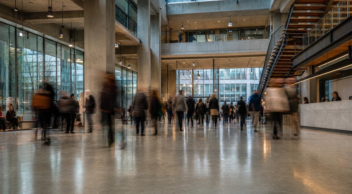 People moving through a bright, modern workspace