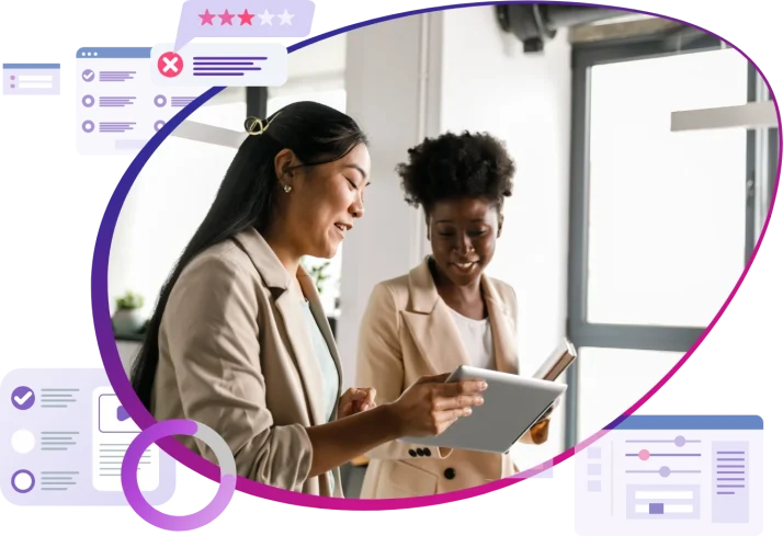 Photo of two women working on a tablet at an office
