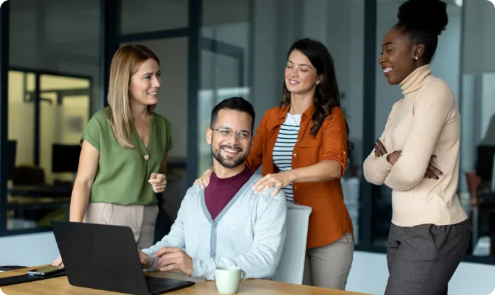 Photo of a group of co-workers working at an office